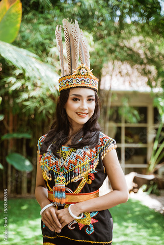 beautiful asian woman in king bibinge standing put her hand in front of her body at the nature photo