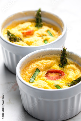 baked eggs with green asparagus, tomato and spring onion