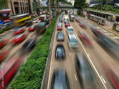 Cars driving along freeway at daylight in Gloucester Road, Hing Kong, long exposure © Dinesh5/Wirestock Creators