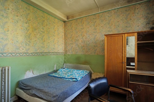 Slum landlord bedroom rental. Insalubrious bedroom. Abandoned room. Careless tenant. Disgusting wallpaper.