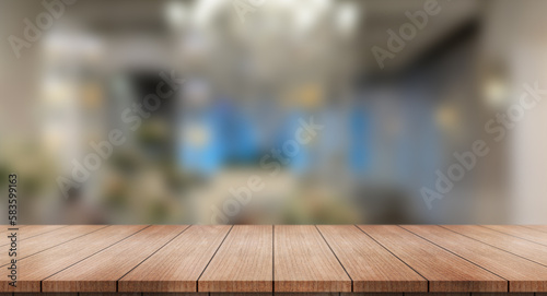 Empty wooden table top with lights bokeh on blur restaurant background.