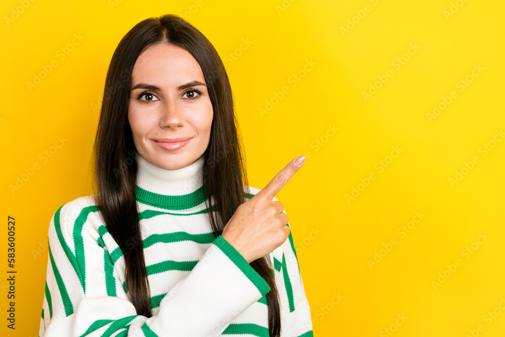 Photo of adorable sweet woman wear striped sweater smiling pointing finger empty space isolated yellow color background Photo of adorable sweet woman wear striped sweater smiling pointing finger empty space isolated yellow color background