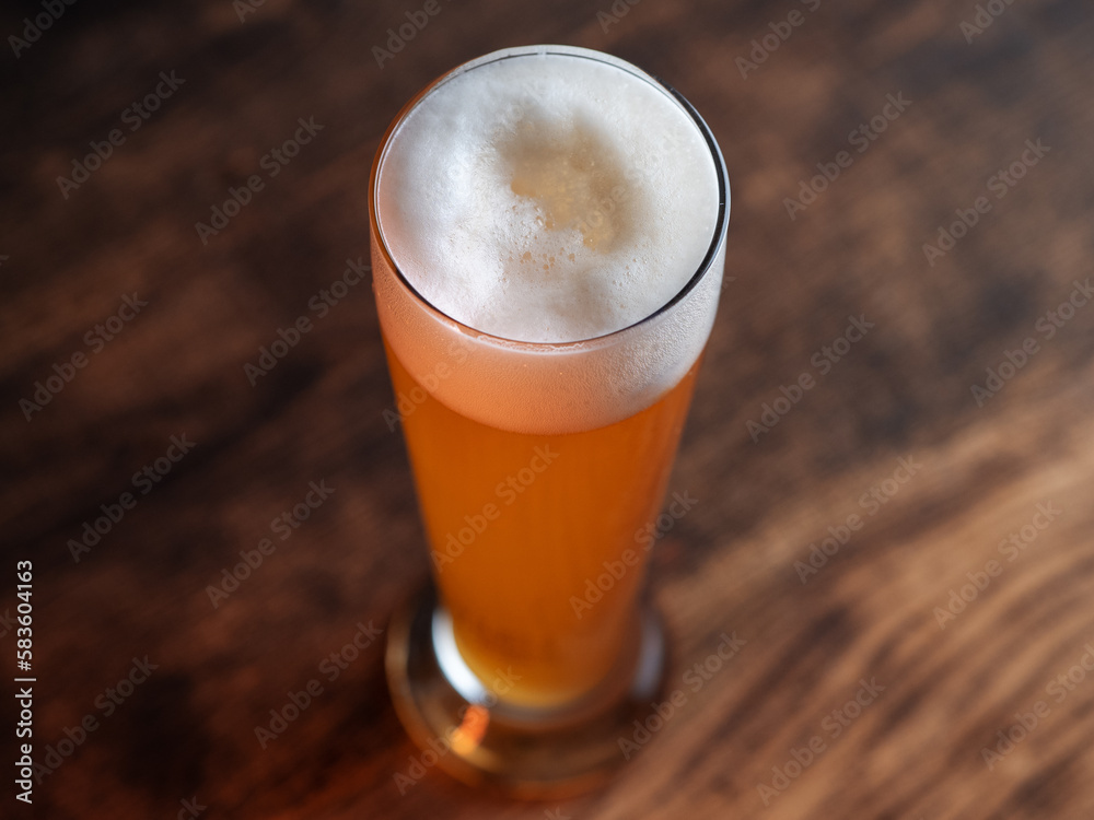 Glass of wheat german beer on wooden table Glass of wheat german beer on wooden table