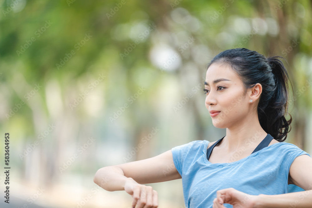 Asian woman stretching body and neck after jogging exercise at park in the city. Attractive athlete girl in sportswear enjoy outdoor lifestyle sport training fitness running workout in morning summer Asian woman stretching body and neck after jogging exercise at park in the city. Attractive athlete girl in sportswear enjoy outdoor lifestyle sport training fitness running workout in morning summer