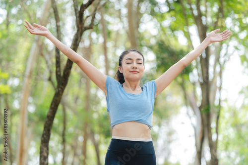 Fitness woman stretching before or after workout, Asian fit girl workout exercise in the morning at nature park outdoor, sport fitness lifestyle for athlete body to wellness healthy