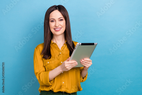 Portrait photo of young assistant office worker lady hold electronic tablet browsing analytics information isolated on blue color background