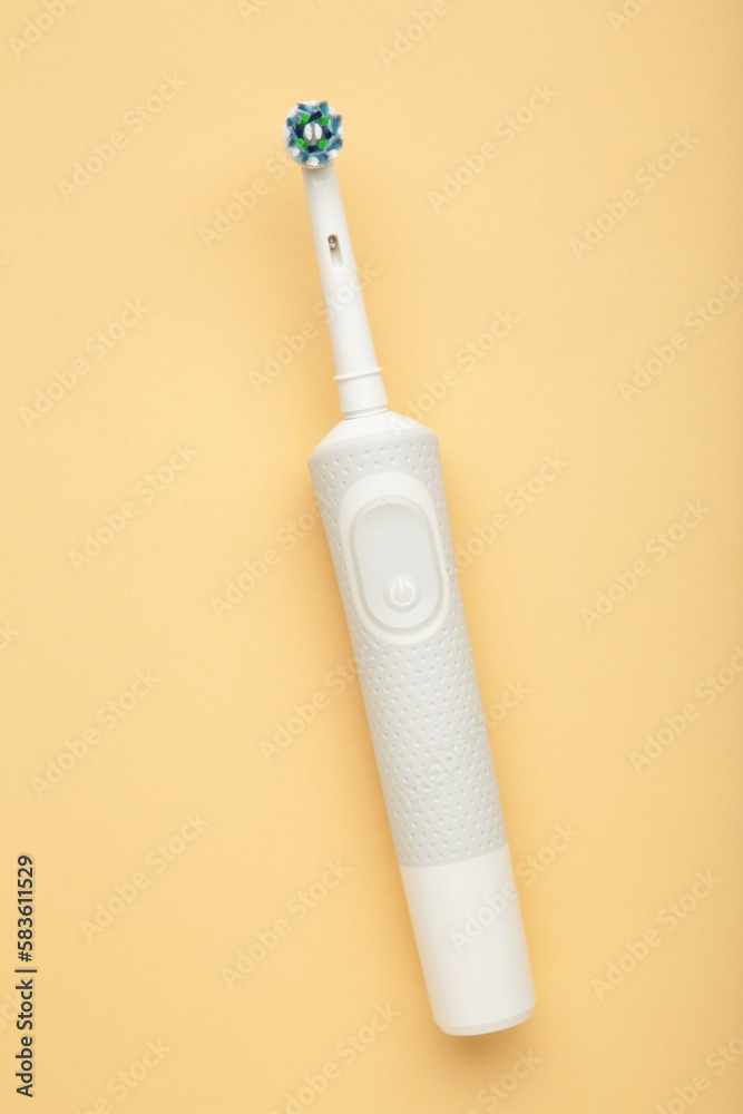 Modern electric toothbrush on beige background. Controlled tool for daily oral care. Modern electric toothbrush on beige background. Controlled tool for daily oral care.