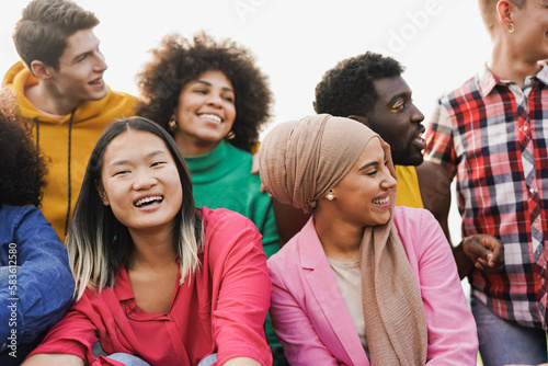 Group of multiracial young people having fun together outdoor - Focus on asian girl face