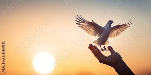 Concept for the International Day of Peace: Hand holding Dove flying against sunset - Generative AI © Bartek