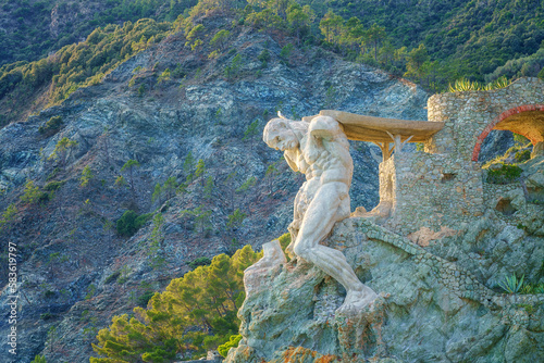 The Giant statue of Monterosso al Mare carved in the rock, symbol of the town, Cinque Terre National Park, Liguria region of Italy. Outdoor travel background