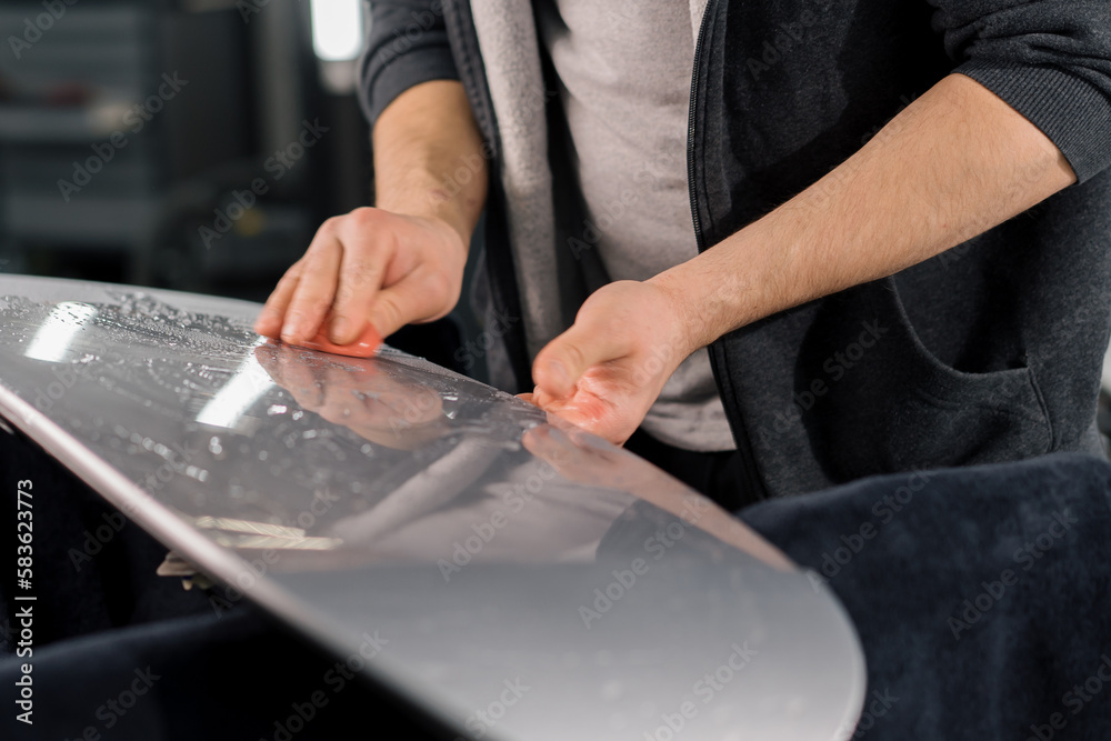 Preparation of a car spoiler for gluing a paint protection film that protects the paint from scratches and stones auto detailing