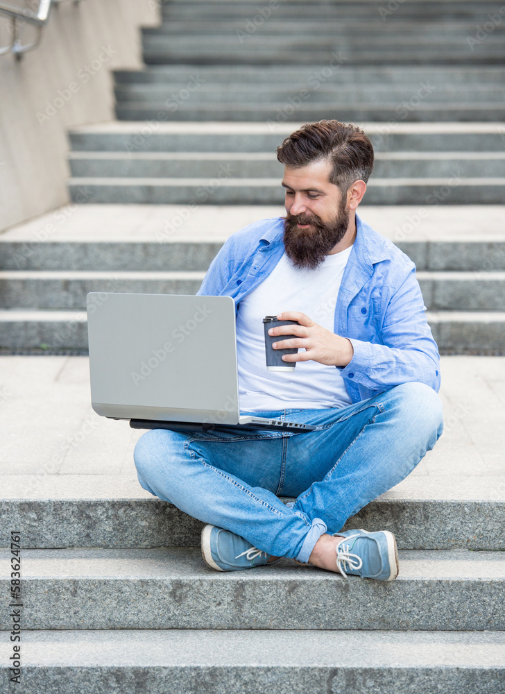 smiling man freelancer has video call outside. man freelancer has video call at coffee break. smiling man freelancer has video call outside. man freelancer has video call at coffee break.