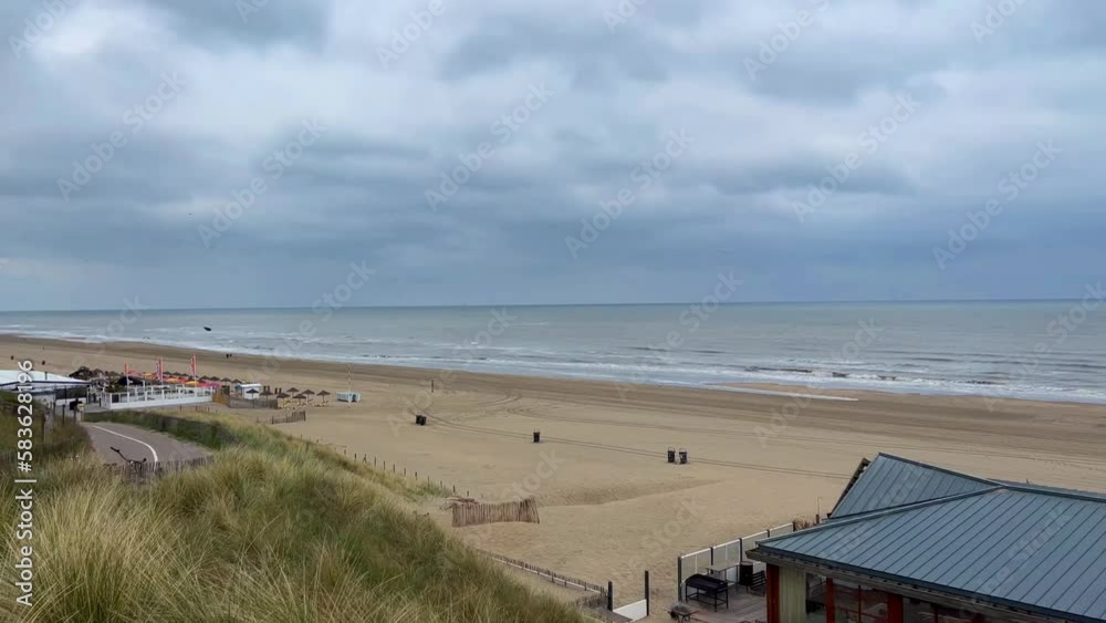Sea coast at sunset. Cafes and restaurants on sandy beach at sunset. Noordwijk, the Netherlands. . High quality 4k footage Sea coast at sunset. Cafes and restaurants on sandy beach at sunset. Noordwijk, the Netherlands. . High quality 4k footage