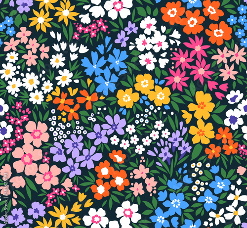 Cute floral pattern in small flowers. Small colorful flowers. Dark blue background. Ditsy print. Floral seamless background. Liberty template for fashion prints. Stock pattern.