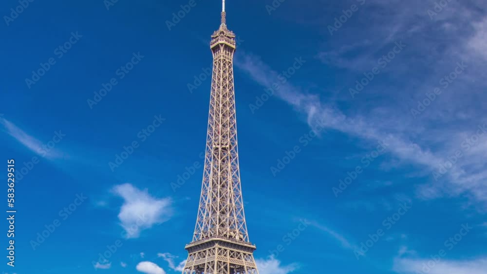 The Eiffel tower aerial timelapse hyperlapse from waterfront at the river Seine in Paris. Ship and boats on river at sunny summer day