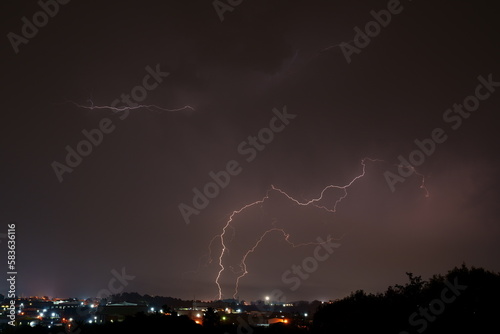 Bright lightning bolts over the commercial and urban area of Kempton Park. The unpredictability of Mother nature at its best. Thunder forming behind a formation of clouds and striking the earth.
