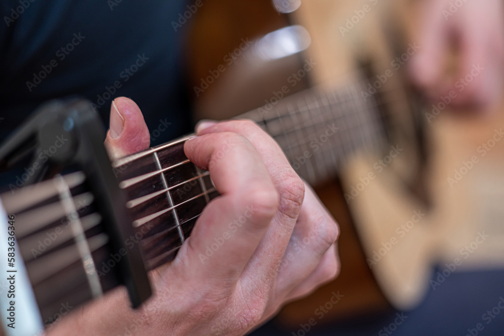 Obraz premium male hands playing acoustic guitar, close up.Acoustic guitar with a beautiful wood .