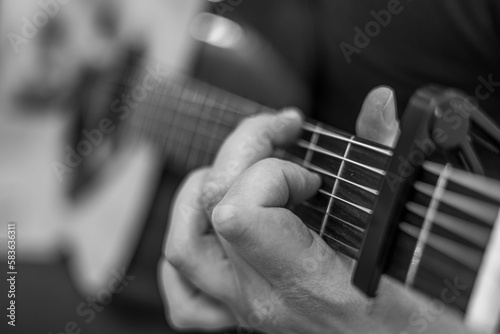 male hands playing acoustic guitar, close up.Acoustic guitar with a beautiful wood .