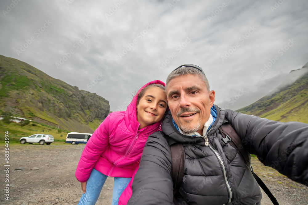 Happy man with his daughter visiting Iceland in summer season Happy man with his daughter visiting Iceland in summer season