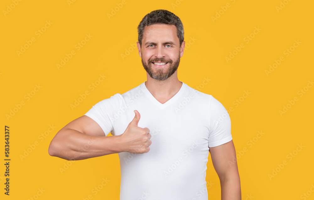 man wearing casual style show thumb up. bearded man in casual shirt isolated on yellow background. man wearing casual style show thumb up. bearded man in casual shirt isolated on yellow background.