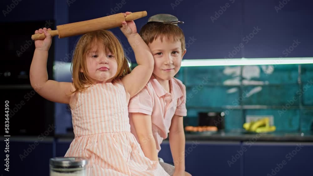 Helping Is Fun Caucasian children in the kitchen having fun helping their parents cook ...