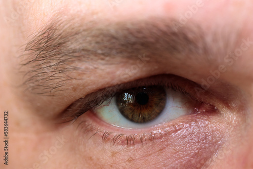 male eye with unpainted eyelashes. close-up.