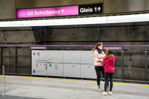 Young girl with her mother in a Vienna subway station