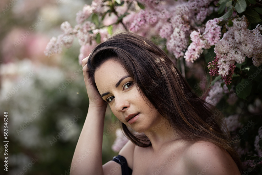 Beauty portrait of a Ukrainian woman posing in front of a lilac tree in bloom. She has brown hair and brown eyes. This photo was taken at the first bloom located in Ottawa, Canada. Beauty portrait of a Ukrainian woman posing in front of a lilac tree in bloom. She has brown hair and brown eyes. This photo was taken at the first bloom located in Ottawa, Canada.