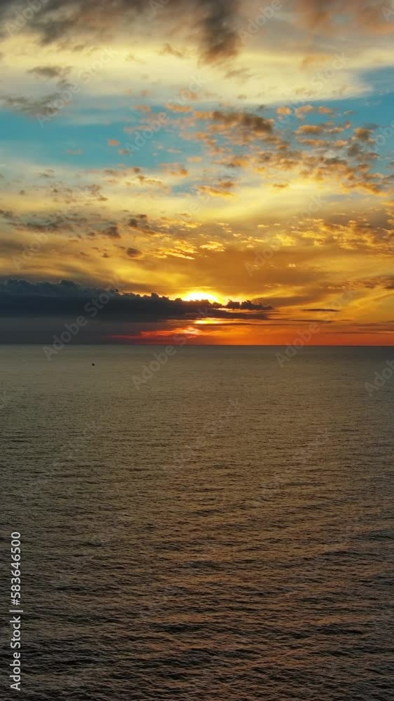 Aerial view of sea surface during a beautiful colourful sunset. Vertical video Aerial view of sea surface during a beautiful colourful sunset. Vertical video