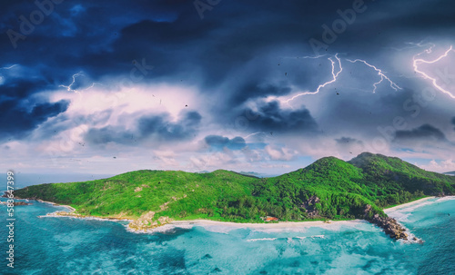 Aerial panoramic view of Tropical Island with storm approaching. Climate change concept