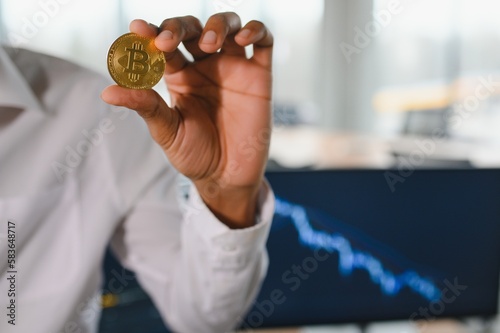 Business man crypto trader investor analyst holding gold bitcoin coin buying cryptocurrency tokens analyzing stock market data investment risks.