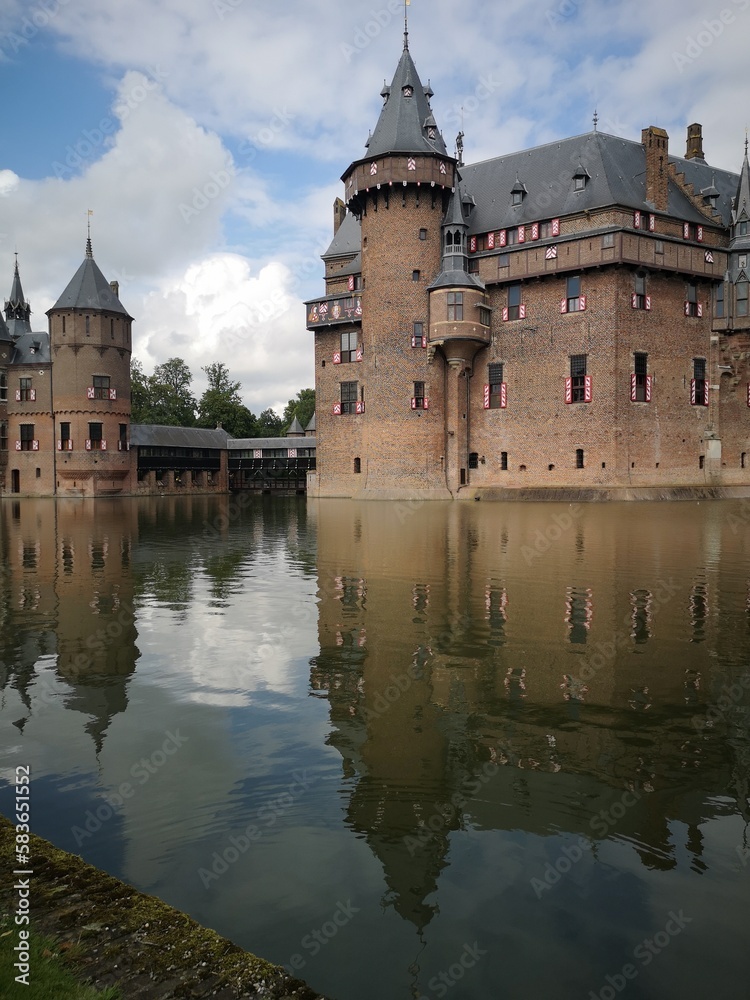 Kasteel de haar with reflections in the water blue sky with some clouds