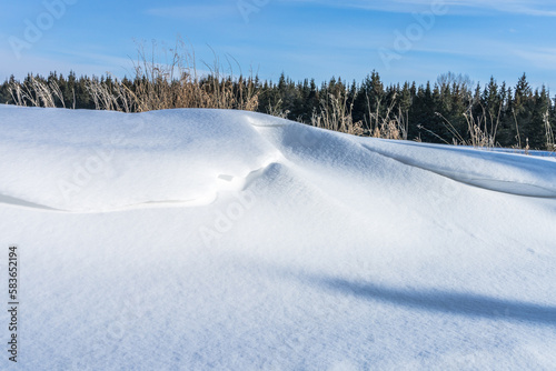 Snowdrift and blues sky background in winter season
