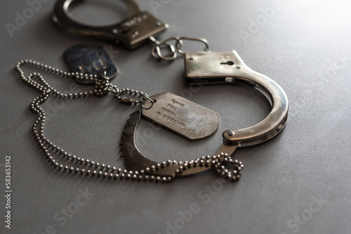 a military badge and handcuffs on a dark background