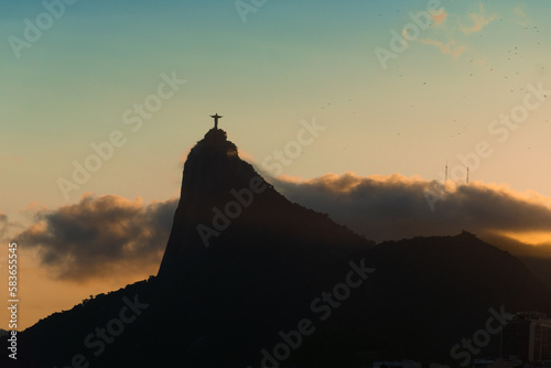 Sunset in the bay of Guanabara  cove and beaches of Rio de Janeiro  Brazil with its buildings  boats and landscape. Christ the Redeemer on top of Corcovado. Reflection of the sky in the sea