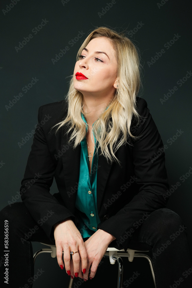 Beautiful blonde woman sitting on a chair Beautiful blonde woman sitting on a chair