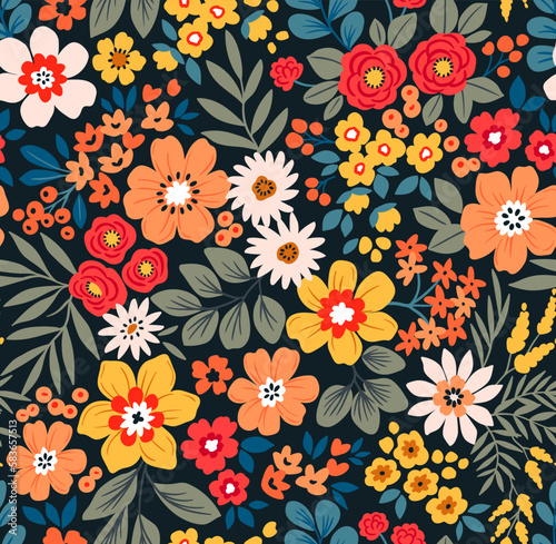 Seamless vector floral pattern. Liberty background of bright colorful abstract flowers. Print with bouquets of flowers from the garden. Bright yellow and red flowers on a dark blue background.