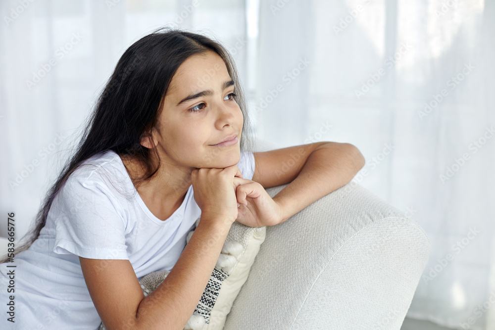 Beautiful pensive preteen 12s girl sit on armchair Beautiful pensive preteen 12s girl sit on armchair