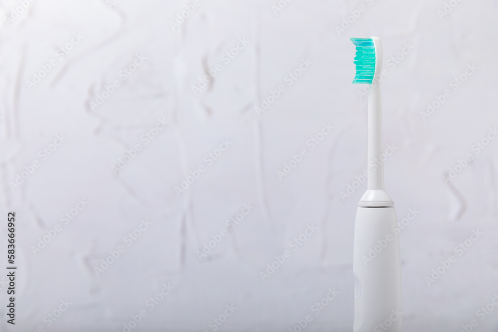 Smart electric toothbrush. Modern technologies for health. Healthy teeth. Dentistry concept. medical robot. Charged via powerbank and controlled by an app on a smartphone. Oral hygiene.copy space. Smart electric toothbrush. Modern technologies for health. Healthy teeth. Dentistry concept. medical robot. Charged via powerbank and controlled by an app on a smartphone. Oral hygiene.copy space.