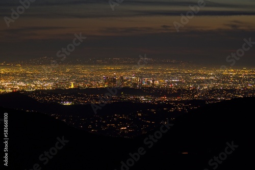 Dusk falls on Los Angeles far below us, from the Angeles Crest Highway in the San Gabriel Mountains