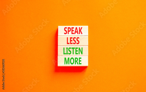 Speak less listen more symbol. Concept words Speak less listen more on wooden block. Beautiful orange table orange background. Motivational business speak less listen more concept. Copy space.