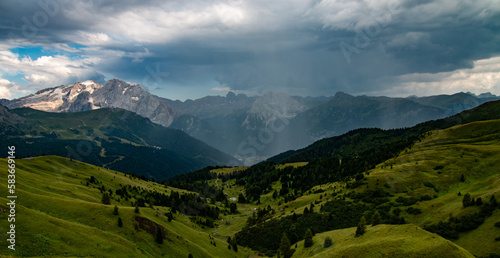 Verdant green meadows, vibrant wildflowers, and majestic mountain peaks - Val Gardena is a picturesque alpine paradise. Sella Pass, Langkofel and Sassolungo, is a breathtaking travel destination.