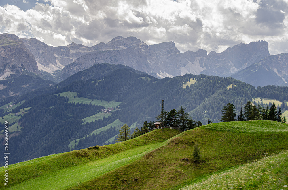 Rolling green meadows above La Val village with Sass de Putia mountain, Alta Badia, Dolomites, South Tyrol, Italy