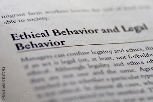 legal or law book with ethical behavior and legal behavior focused in closeup of explanation photo