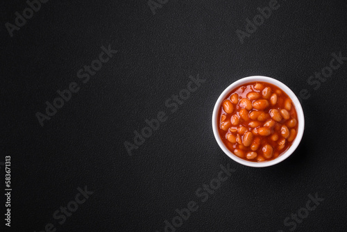 Delicious canned beans in a tomato in a white ceramic bowl
