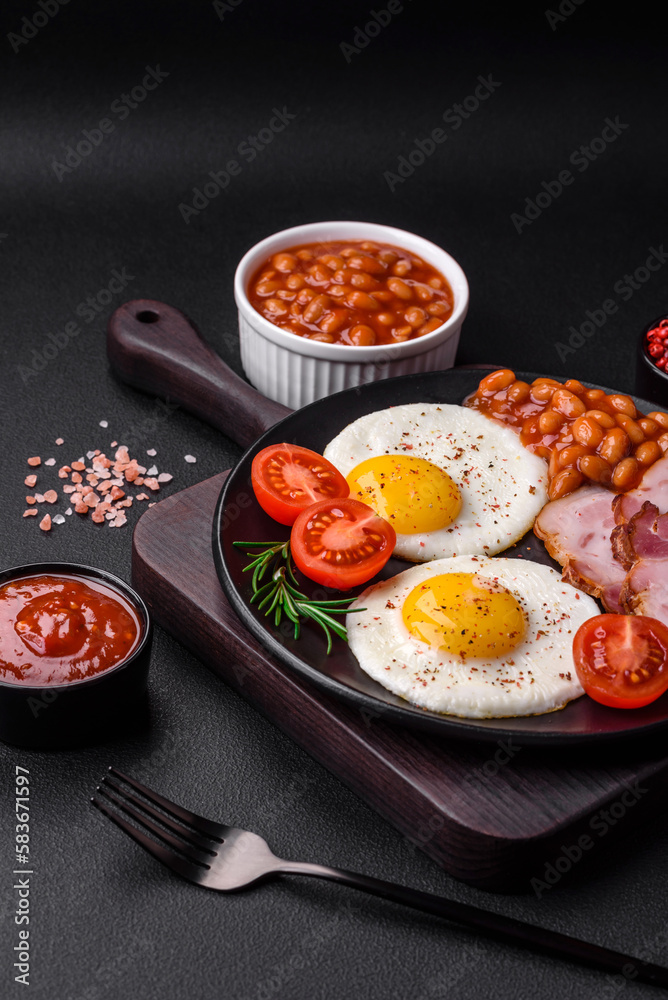 Delicious nutritious English breakfast with fried eggs and tomatoes