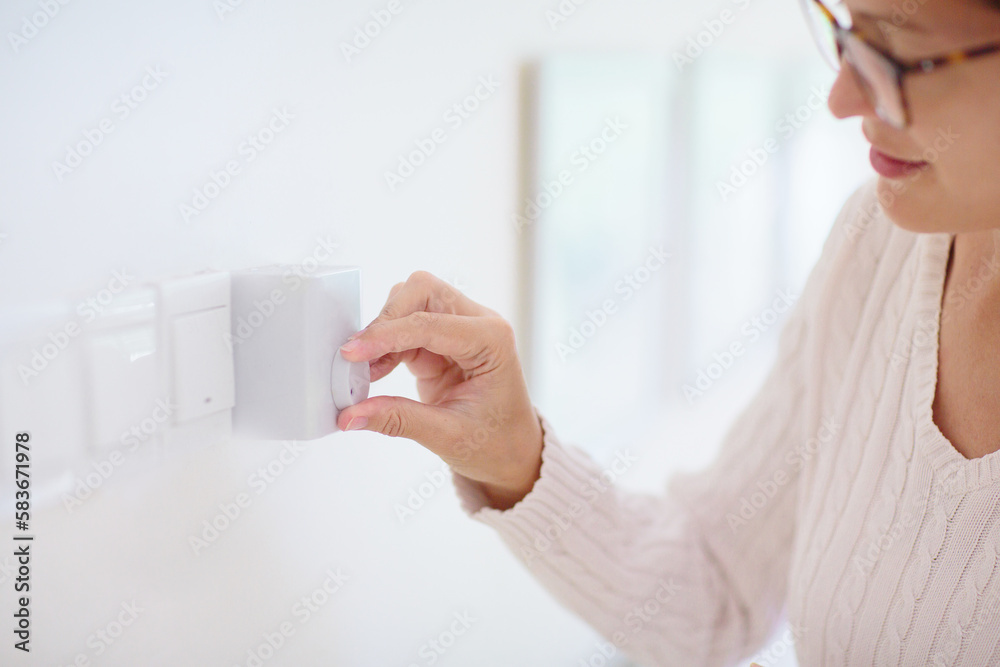 Woman adjusting thermostat. Central heating. Woman adjusting thermostat. Central heating.