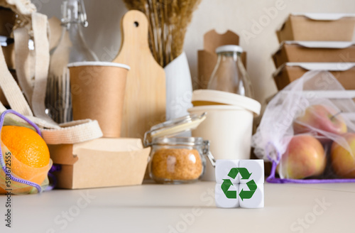 Cubes with a recycling sign against the background of eco-friendly items made from biodegradable materials. Zero waste life concept