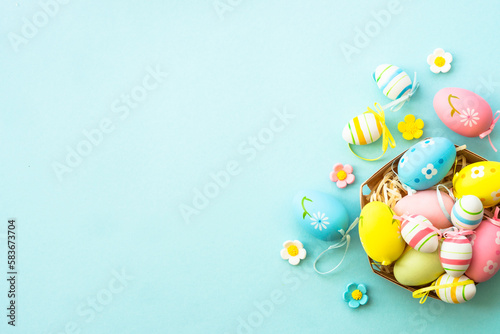 Easter eggs on blue background. Flat lay image with copy space.