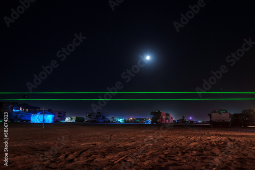 Night lights in the middle of a desert at the camp at BurningMan festival. Beautiful music festival in a desert.at night at the Burning Man Festival. photo